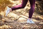 Running, fitness and shoes of woman in nature park for workout, health and cardio training. Wellness, sports and stamina endurance with girl runner jogging in forest for progress goals, exercise