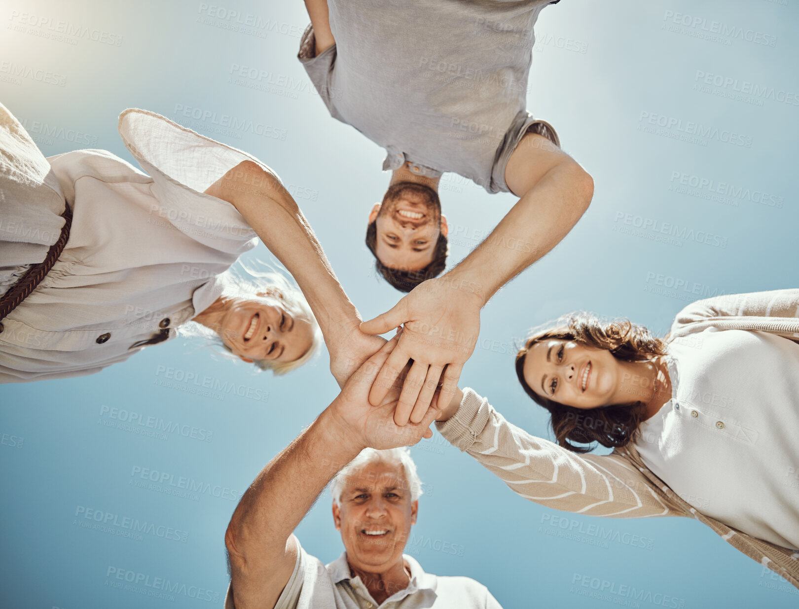 Buy stock photo Low angle, support and hands pile portrait of happy family in park bonding, house garden or home nature backyard. Solidarity, community and teamwork stack for parents, senior man or women on blue sky
