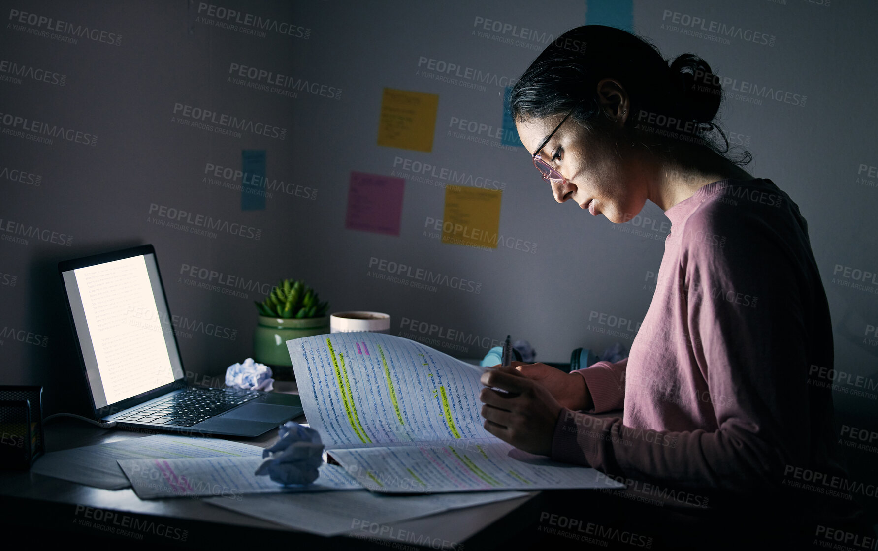 Buy stock photo Student, reading notebook and studying at night with laptop of learning, education or internet project. Young woman, research paper and writing at dark desk for planning college homework in dormitory