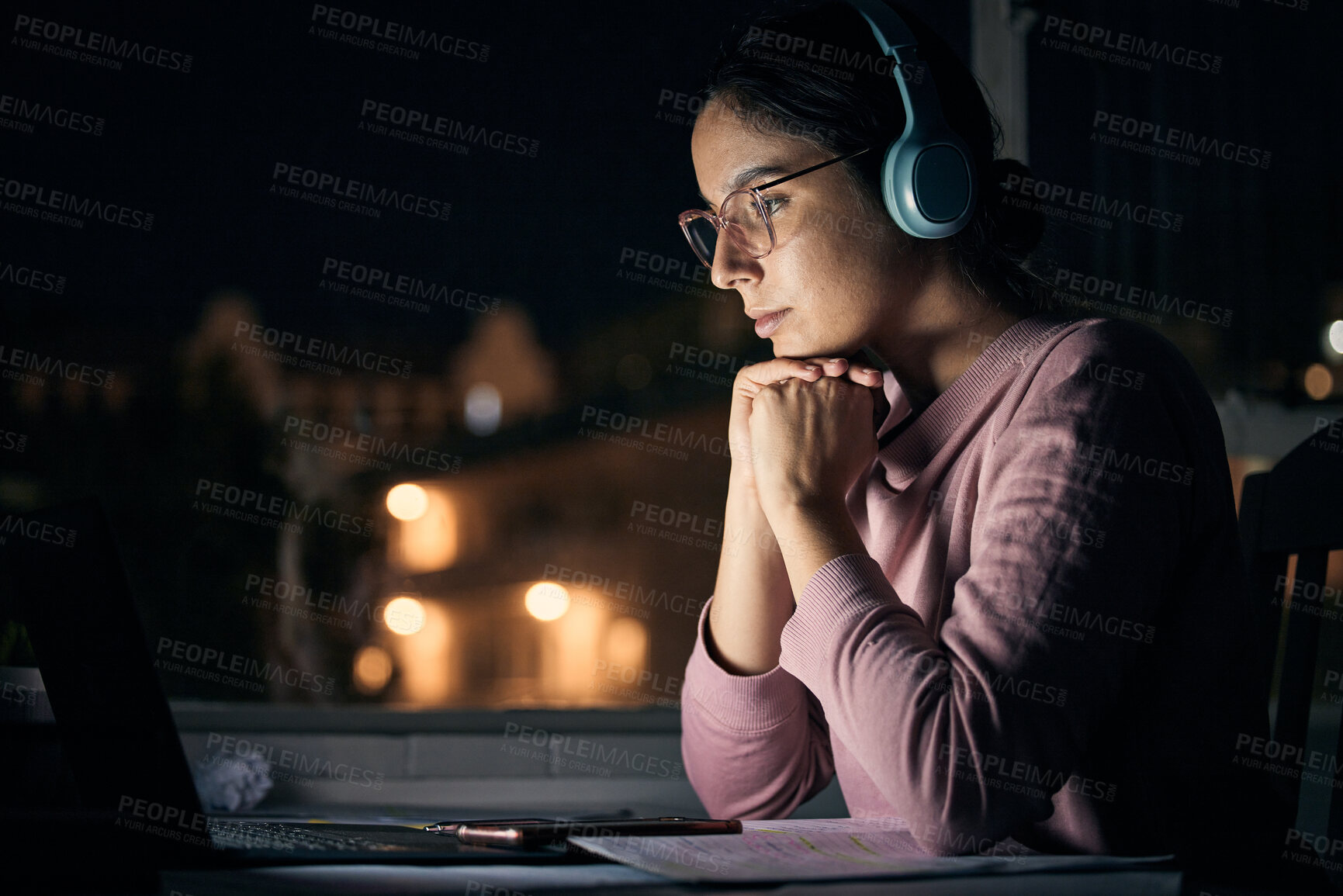Buy stock photo Laptop, night and music with a student woman in her home for learning, education or development using the internet. Computer, research and elearning with a female pupil studying late in a dark house