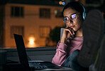 Creative woman, laptop and thinking at night for deadline, project or working late at office. Business woman relaxing by desk in thought for planning on computer in evening for startup at workplace
