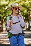 Tourist, backpack and phone call in travel, sightseeing and adventure in nature woods, forest and trees park with coffee. Happy smile, backpacking and talking woman on mobile communication technology