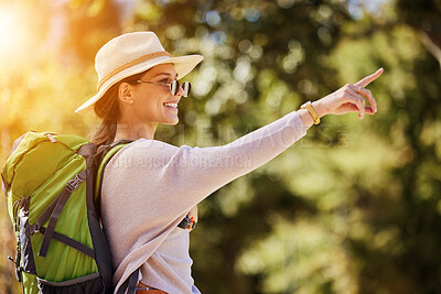 Buy stock photo Happy woman, backpack or pointing in nature travel, sightseeing park or bird watching adventure in trees forest. Smile, tourist and direction hand in hiking location, Canada woods or interface search