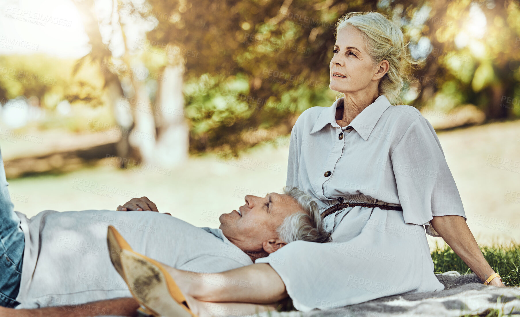 Buy stock photo Retirement, love and relax with a senior couple outdoor in nature for a picnic on a green field of grass together. Happy, smile and date with a mature man and woman bonding outside for romance
