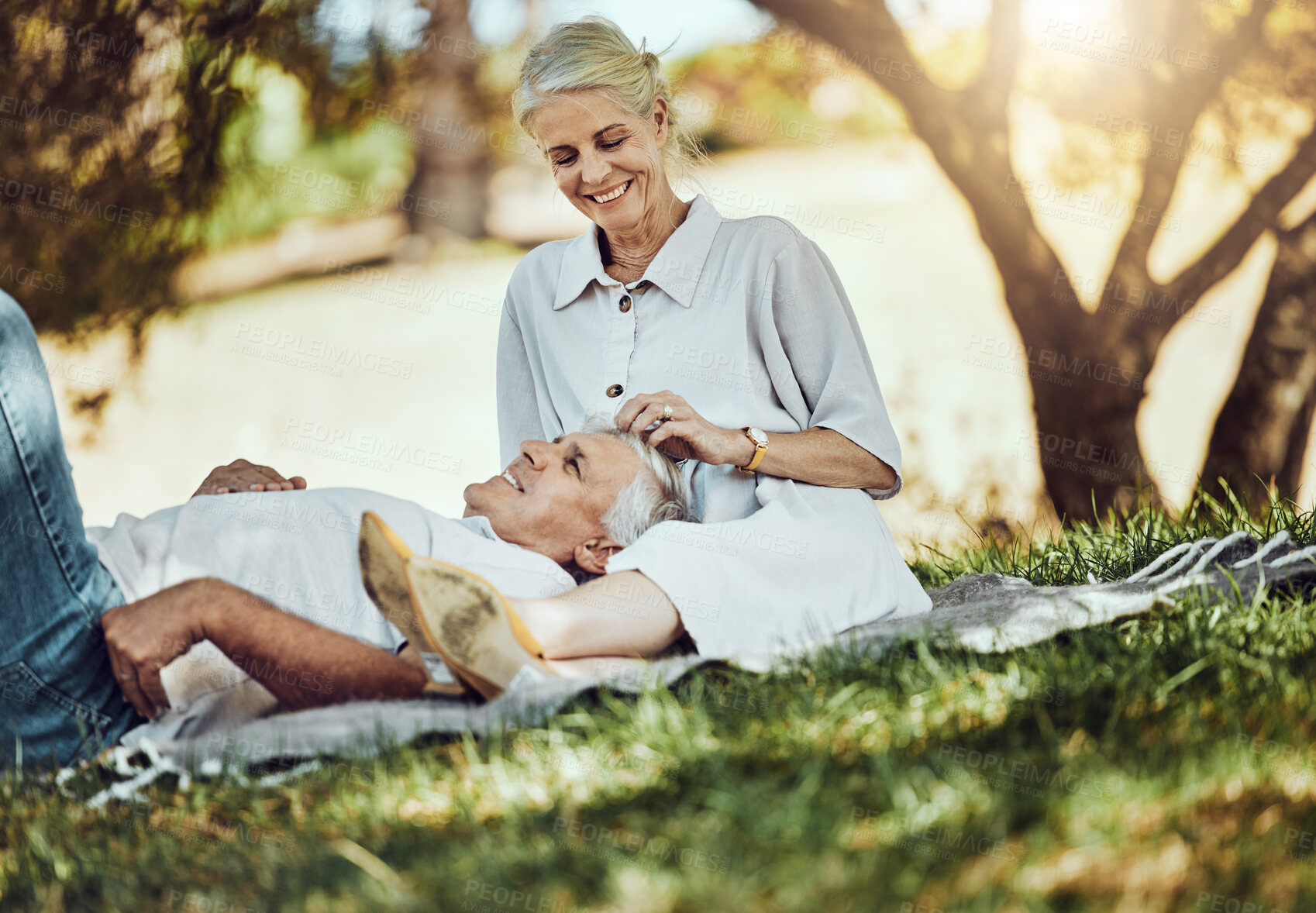 Buy stock photo Retirement, love and picnic with a senior couple outdoor in nature to relax on a green field of grass together. Happy, smile and date with a mature man and woman bonding outside for romance