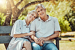 Love, retirement and portrait of couple on park bench with smile, relax and bonding time in nature together. Romance, senior man and retired woman in garden, happy people and romantic summer weekend.