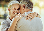 Hug, affection and portrait of a senior couple in nature for bonding, quality time and care in France. Smile, happy and face of an elderly woman hugging a man for romance in retirement in a park