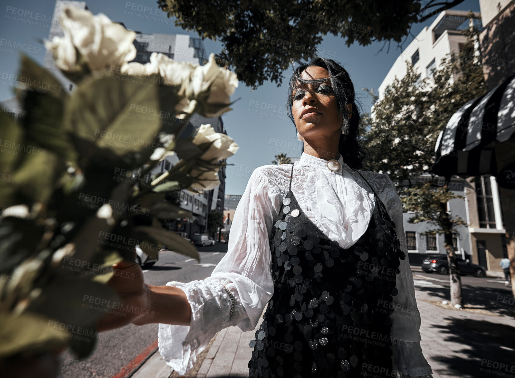 Buy stock photo Fashion, young woman in city with rose, nature and urban designer clothes, glamour and creative with art in street. Trendy, natural beauty and bouquet, summer with stylish model, cosmetic and sparkle