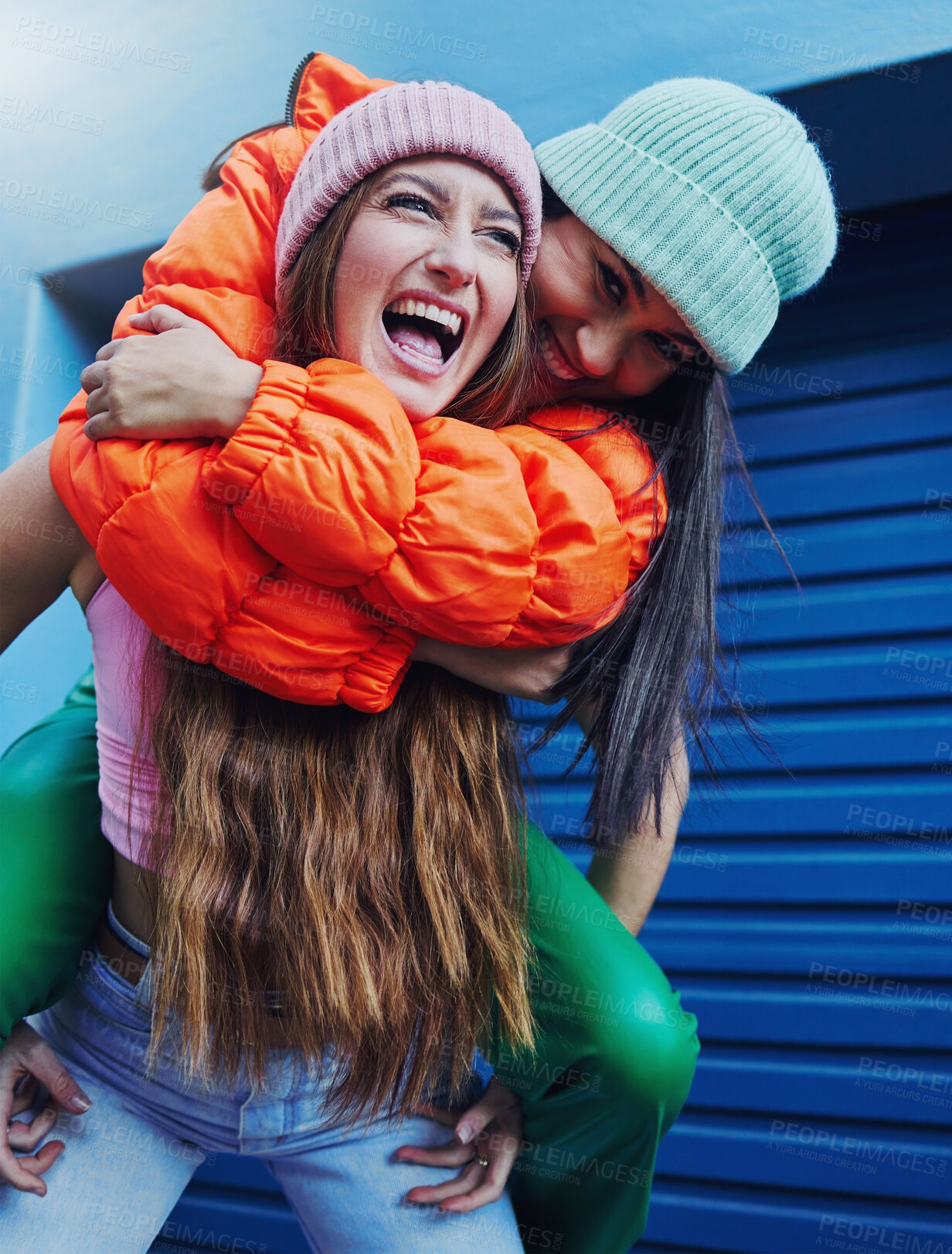 Buy stock photo Friends, city fashion and piggyback girl with outdoor adventure, funny and comic face with happiness together. Gen z women, metro and blue background for trendy clothes, smile and happy in street