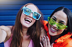 Selfie, gen z and portrait of fun women in the city with fashion, sunglasses and happy in Korea. Smile, stylish and face of friends with a photo, streaming and crazy on a blue wall with style