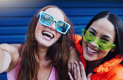 Buy stock photo Selfie, gen z and portrait of fun women in the city with fashion, sunglasses and happy in Korea. Smile, stylish and face of friends with a photo, streaming and crazy on a blue wall with style