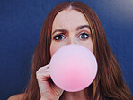 Closeup portrait, girl and bubblegum by wall, outdoor and urban adventure for funny, comic face and happy. Gen z woman, city and blue background with pink chewing gum, bubble and blowing for fun game