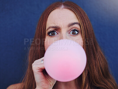 Buy stock photo Closeup portrait, girl and bubblegum by wall, outdoor and urban adventure for funny, comic face and happy. Gen z woman, city and blue background with pink chewing gum, bubble and blowing for fun game