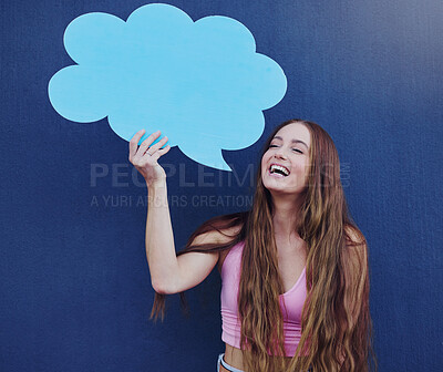 Buy stock photo Happy woman holding a chat board with mockup space standing by a blue wall with a sign. Gen z, happiness and young female with a speech bubble with mock up or copy space for marketing or advertising.