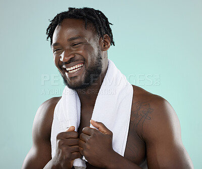 Buy stock photo Face, skin and beauty of a man in studio with towel for hygiene and grooming. Healthy and happy black person on blue background for facial glow, cosmetics and self care with skincare dermatology