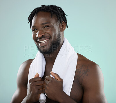 Buy stock photo Man, face portrait and skin in studio with towel for hygiene and grooming. Healthy and happy black person on blue background for facial glow, cosmetics and self care with dermatology skincare brand