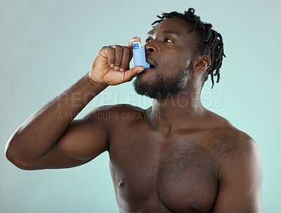 Buy stock photo Asthma pump, sick and man in a studio with bronchitis, illness or medical chest problems. Inhaler, healthcare and African male doing a asma treatment with medication isolated by a blue background.