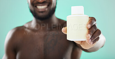 Buy stock photo Black man, hands and skincare cosmetics, product or serum bottle for facial or body treatment against studio background. Hand of African American male holding solution for skin, advertising or brand