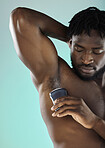 Grooming, hygiene and black man with armpit deodorant isolated on a blue background in studio. Skincare, cleaning and African model with a product for body odor and morning routine on a backdrop