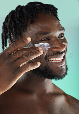 Buy stock photo Black man, face and cream with smile and beauty, moisturizer for skincare isolated on studio background. Healthy skin, cosmetic care and happy model apply lotion, facial and wellness with cosmetics