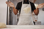 Baking, dough and hands of a cook in the kitchen for cooking food, bread or a pastry in a bakery. Fast food, job and man preparing a breakfast, lunch or dinner on a table of a shop for a meal