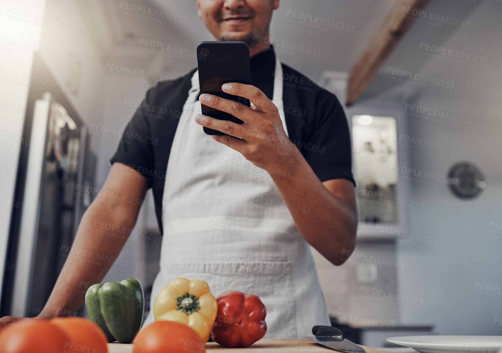 Buy stock photo Cooking vegetables, phone and man in kitchen while online with house wifi connection for learning on food blog. Chef person with mobile app for online recipe for home food for vegan or healthy eating