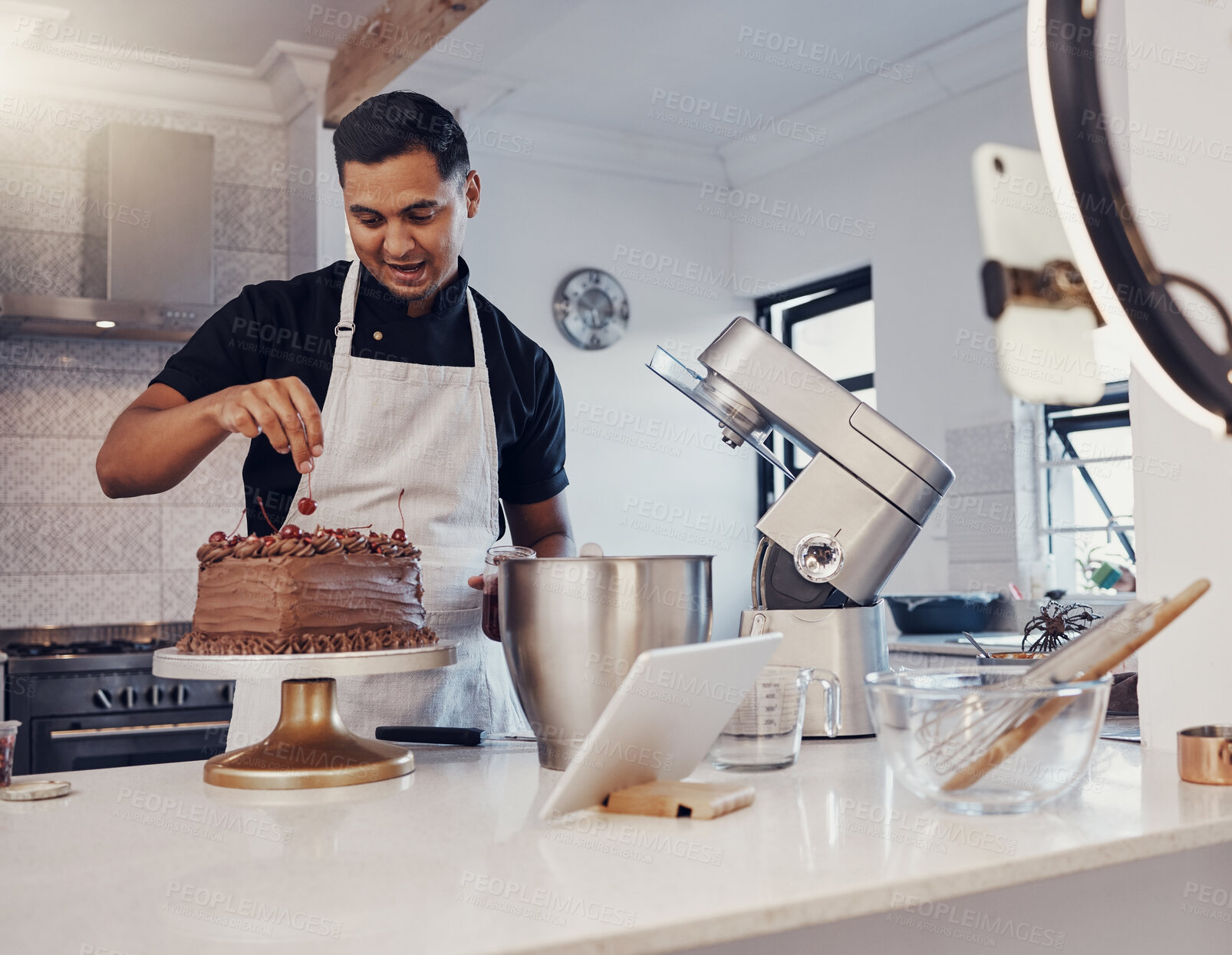 Buy stock photo Man, vlog and baking chocolate cake in kitchen, live streaming and recording a dessert tutorial on social media. Happy chef, digital content creator or food influencer filming a virtual cooking class