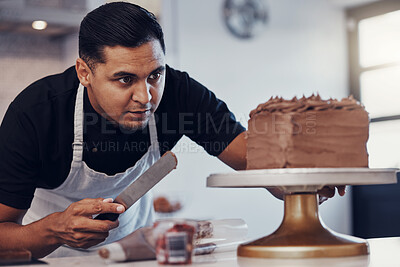 Buy stock photo Baking, kitchen and man icing cake with chocolate frosting and piping bag in bakery with focus and skill. Sweets, small business and baker decorating dessert for birthday event and working from home.