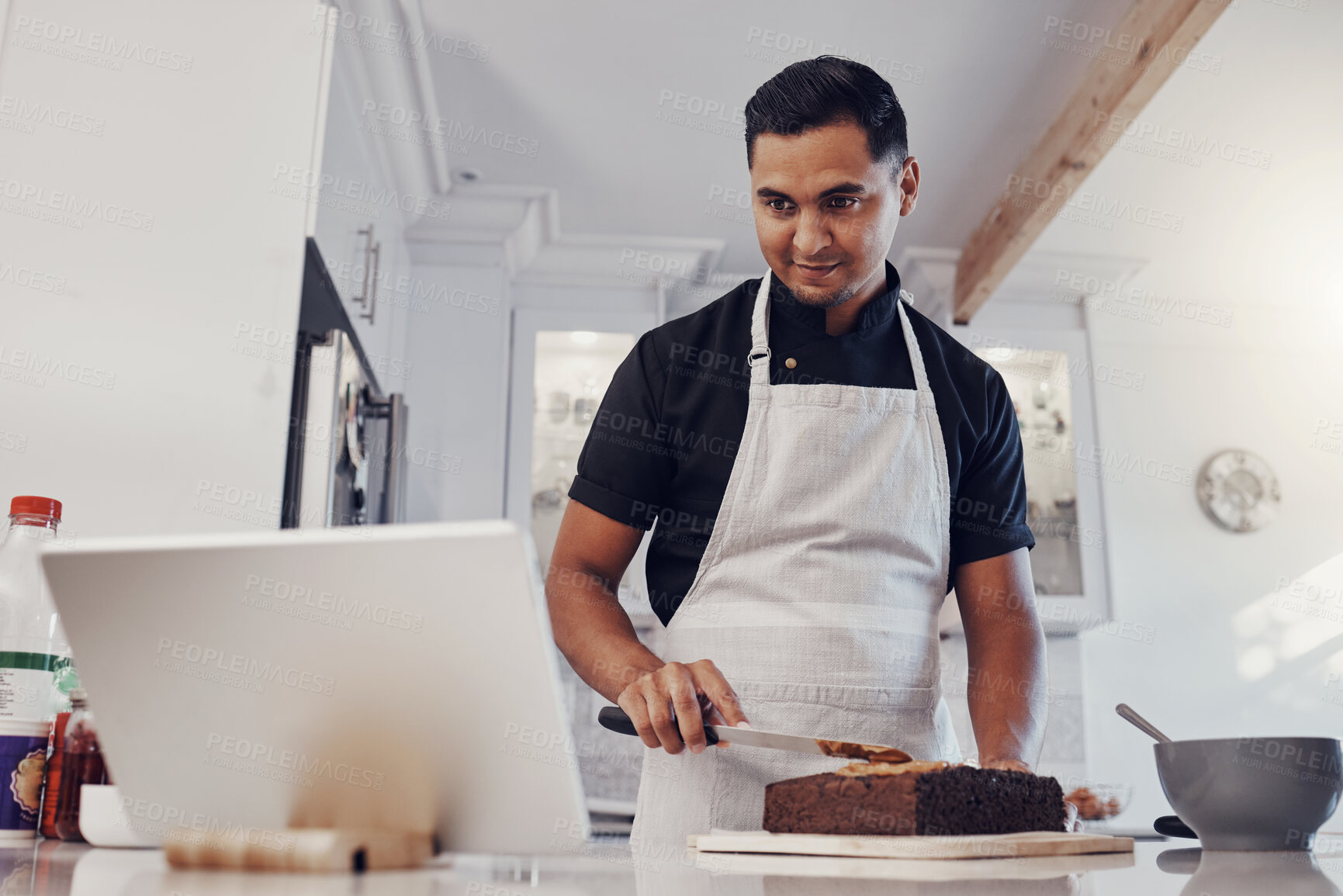 Buy stock photo Man, tablet and baking cake recipe in kitchen for birthday party or celebration. Young chef, reading cooking website and bake dessert product on counter for wellness on digital tech device