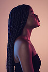 Calm, beauty and black woman with braids in studio with makeup, cosmetic and face routine. Sensual, cosmetics and African female model with relaxing, peace and zen mindset isolated by pink background