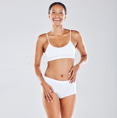 Body, legs and tape measure with a woman in studio on a gray background  measuring for weightloss. F Stock Photo by YuriArcursPeopleimages