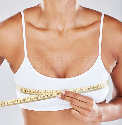 Chest, measure tape and woman isolated on white background for breast cosmetics, plastic surgery and lose weight. Liposuction, health or wellness person or model with boobs for beauty results in zoom