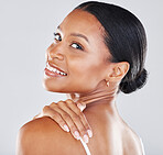 Portrait, face and hand on shoulder with a model black woman in studio on a gray backgrouns for wellness. Health, luxury and beauty with an attractive young female posing to promote skincare