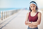 Fitness, portrait and woman with arms crossed at beach promenade for exercise, wellness and mockup in Miami. Female sports athlete standing at seaside outdoor for workout, summer training and running