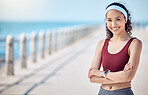 Happy woman, portrait and fitness with arms crossed at beach promenade for exercise, wellness and mockup in Miami. Female athlete, smile and standing at seaside for workout, summer training or sports