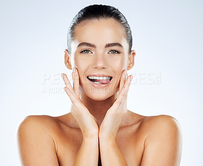 Buy stock photo Beauty, face and skincare portrait of a woman in studio with natural glow skin and white teeth. Aesthetic model person biting on tongue for facial dermatology and spa wellness on a bright background