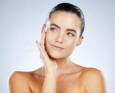 Buy stock photo Skincare, beauty and face of a woman with a glow isolated on a grey studio background. Cosmetics, dermatology and young healthy model thinking of facial wellness, collagen and body detox on backdrop