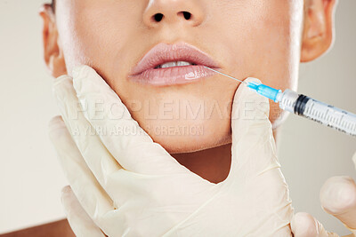 Buy stock photo Skincare, mouth and collagen, woman with injection in lips from healthcare professional, anti aging treatment in studio. Beauty, needle and model with facial lip filler syringe on white background.
