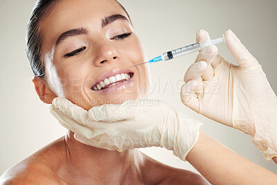 Buy stock photo Smile, beauty and woman with injection in lips from healthcare professional, anti aging wrinkle treatment in studio. Collagen, skincare and model with facial lip filler syringe on white background