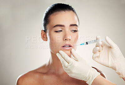 Buy stock photo Skincare, beauty and woman with injection in lips from healthcare professional, anti aging wrinkle treatment in studio. Collagen, needle and model with facial lip filler syringe on white background.