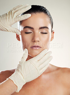 Botox, beauty and plastic surgery with hands on woman face for dermatology collagen cosmetics. Headshot of skincare model person with cosmetologist gloves for cosmetic filler for facial skin lines