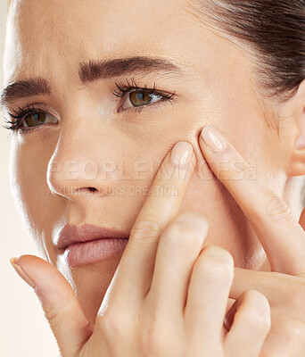 Buy stock photo Face, hands and pimple with a woman checking or examining her skin for acne problems in studio. Facial, fingers and breakout with an attractive young female indoor to squeeze or pop a blackhead