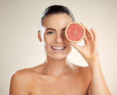 Buy stock photo Skincare, beauty and woman portrait with grapefruit for natural skin dermatology or cosmetics. Vitamin c fruit on happy face aesthetic model in studio for sustainable health and wellness self care