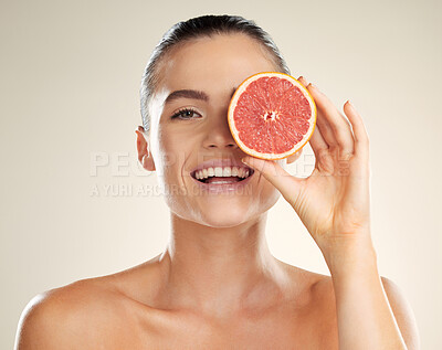 Buy stock photo Beauty, skincare and grapefruit for portrait of a woman with natural skin dermatology product. Vitamin c fruit on face aesthetic model in studio for sustainable cosmetics for health and wellness