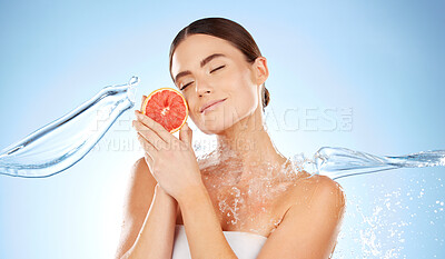 Buy stock photo Beauty, skincare and woman with grapefruit and water for natural skin dermatology. Clean splash and face of aesthetic model in studio for sustainable fruit self care for health and spa wellness