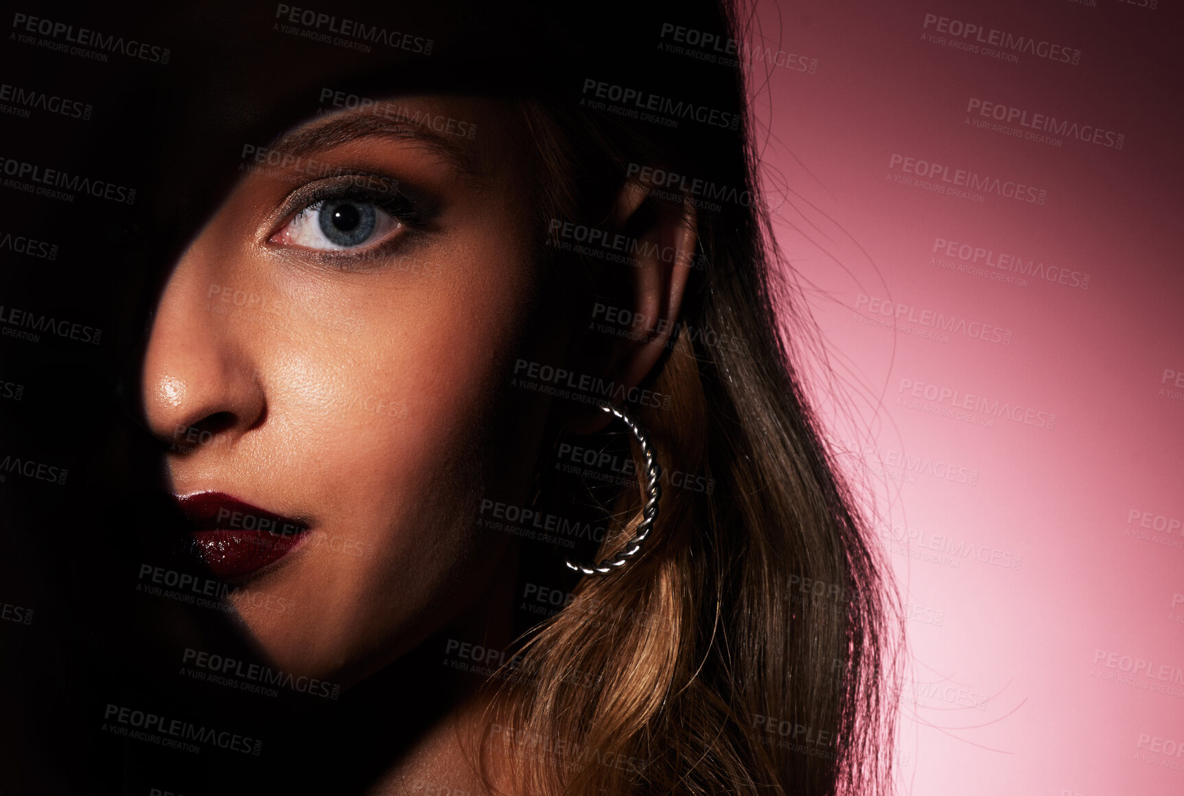 Buy stock photo Glamour makeup and face of woman with spotlight shadow for hidden beauty aesthetic portrait of people zoom in studio. Skincare and dark lipstick style of attractive person in isolated pink background