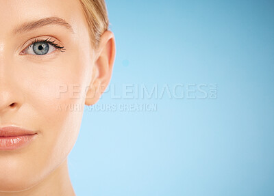 Buy stock photo Skincare, beauty and half portrait of a woman for dermatology isolated on a blue background. Makeup, wellness and face of a model for cosmetics, health and collagen with mockup space on a backdrop