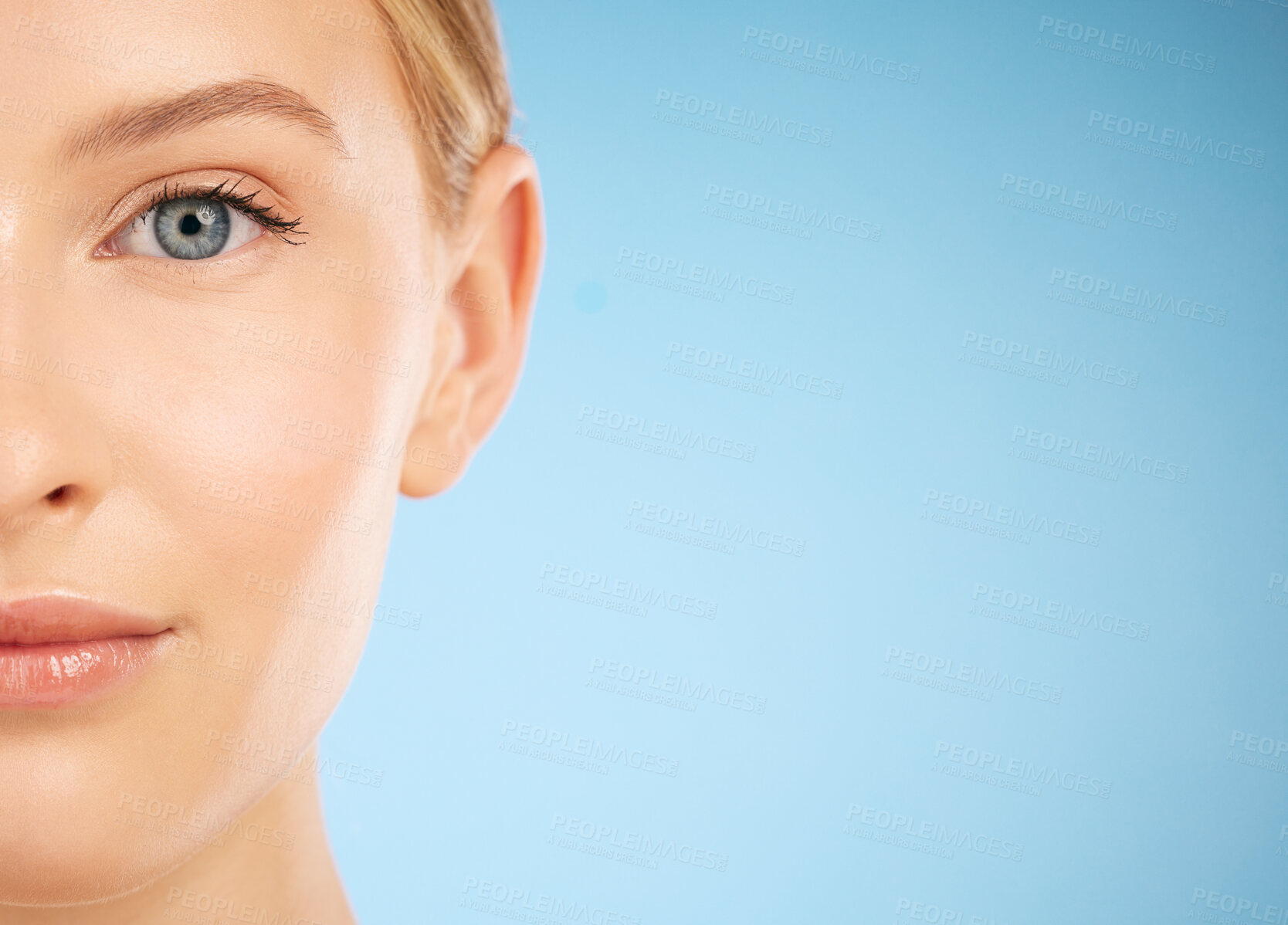 Buy stock photo Skincare, beauty and half portrait of a woman for dermatology isolated on a blue background. Makeup, wellness and face of a model for cosmetics, health and collagen with mockup space on a backdrop