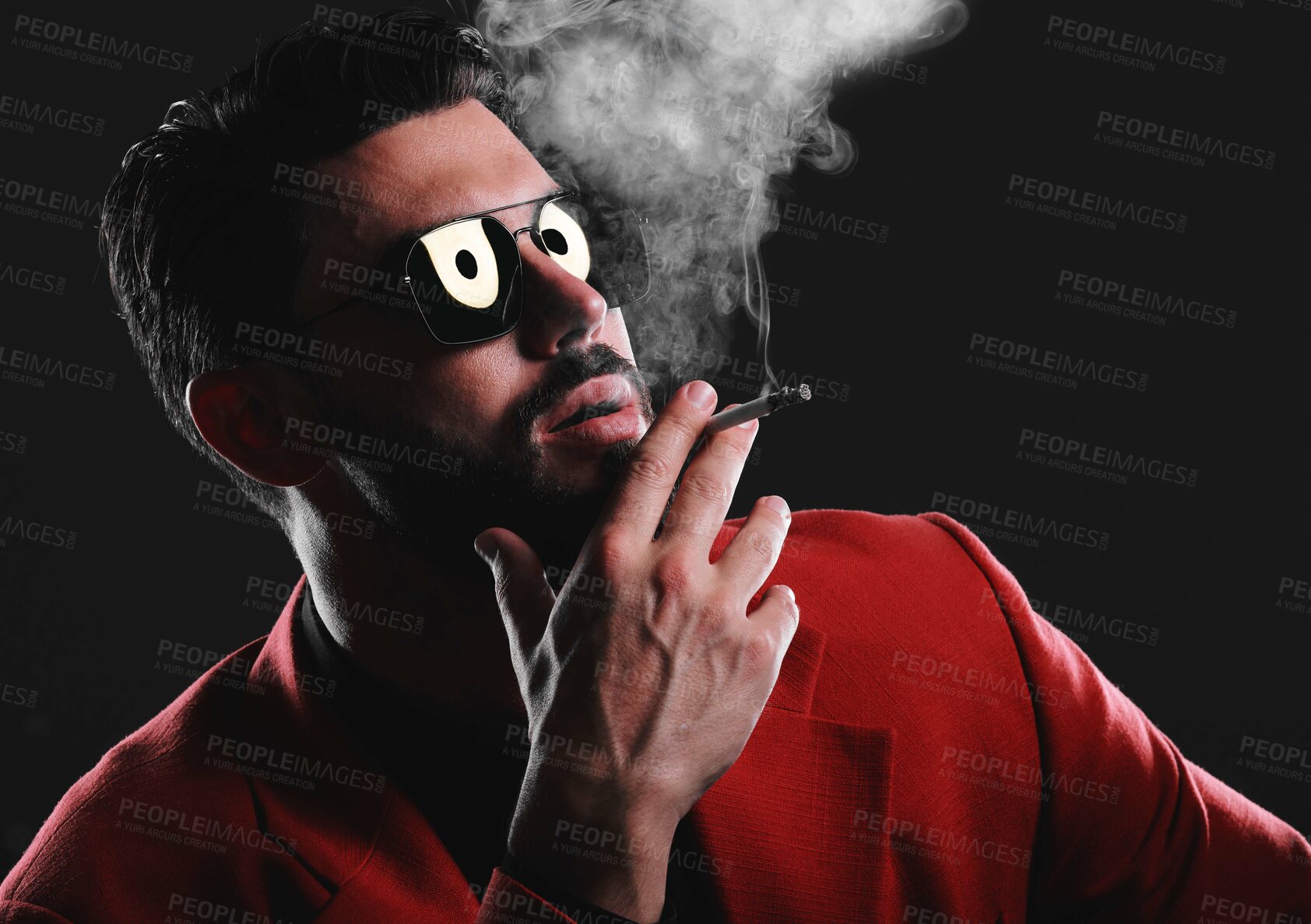 Buy stock photo Fashion, smoke and face with a man model in studio on a dark background wearing a suit for style. Smoking, mafia and edgy with a handsome young male posing on black space holding a cigarette