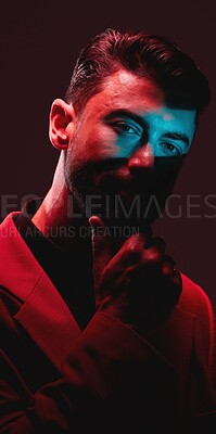 Buy stock photo Future, fashion and reflection, portrait of man with eyes in neon lighting with serious expression on face. Futuristic art, male model and beauty with red and blue studio lights on dark background.